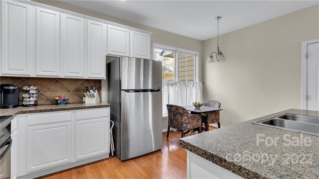 3221 Fifth Baxter Crossing Fort Mill, SC 29708 - Photo 15 of 30 a kitchen with stainless steel appliances granite countertop a refrigerator sink and white cabinets