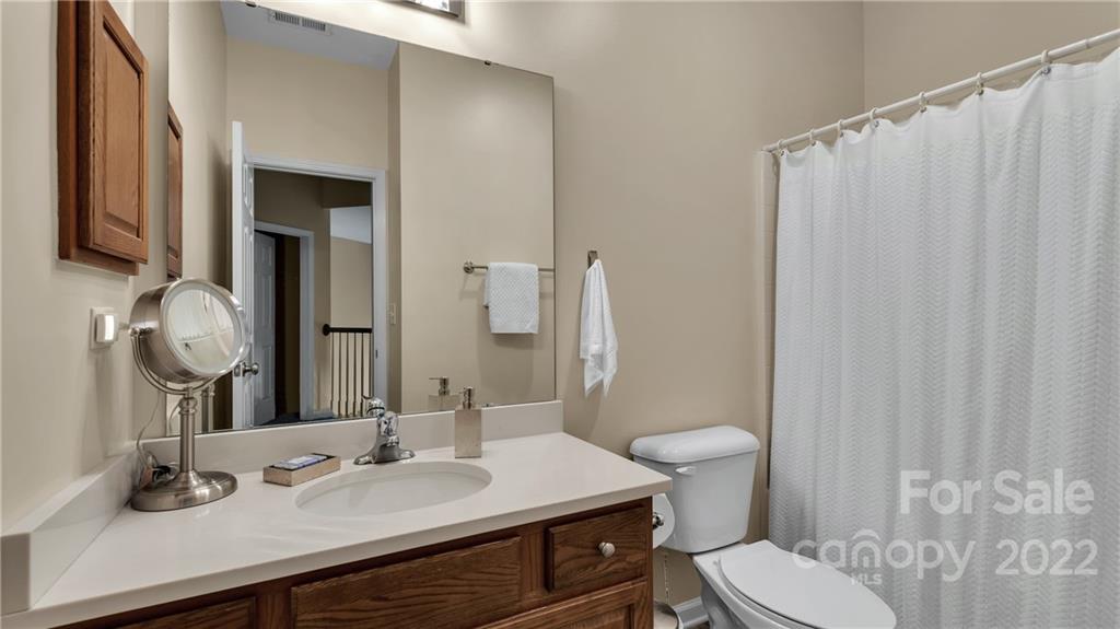 3221 Fifth Baxter Crossing Fort Mill, SC 29708 - Photo 24 of 30 a bathroom with a granite countertop sink toilet and a mirror