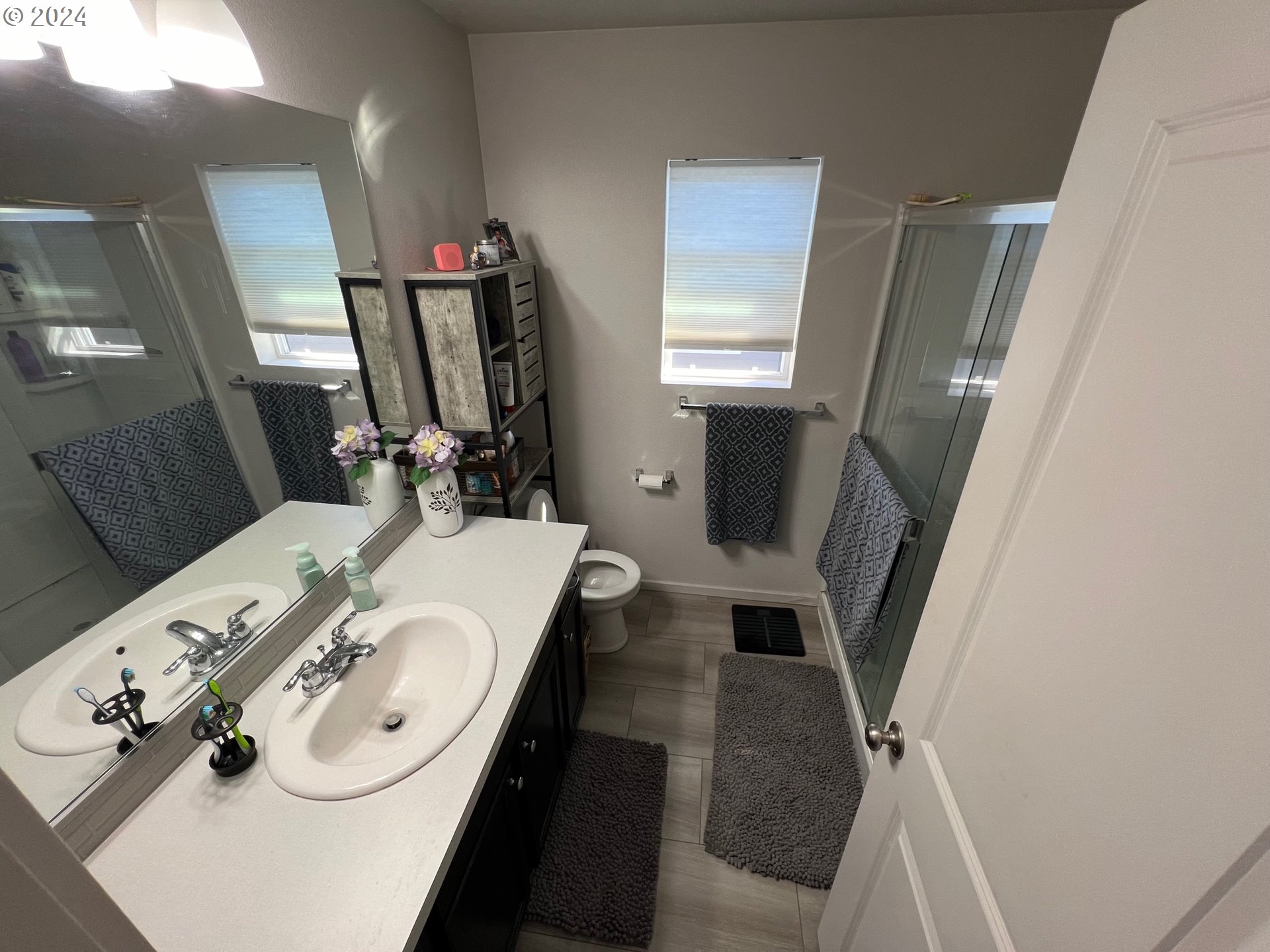 2044 South Chukar Drive Ridgefield, WA 98642 - Photo 9 of 16 a bathroom with a sink a toilet and a mirror