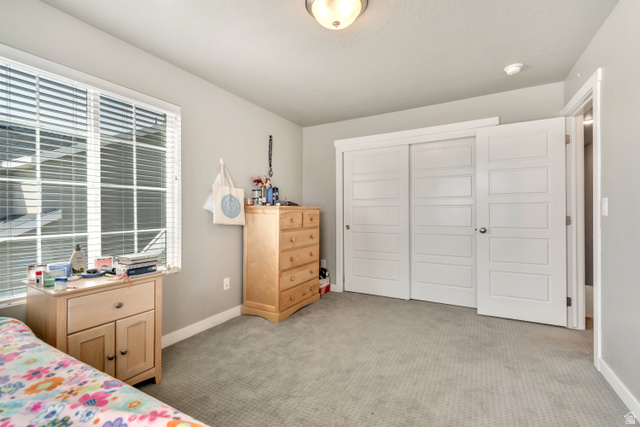 3232 West 1670th Street North Provo, UT 84601 - Photo 19 of 33 Bedroom with light colored carpet and a closet