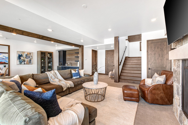 1282 Chimney Rock Road, Unit 344 Heber City, UT 84032 - Photo 30 of 55 Spacious living area featuring exposed wood beams, recessed lighting, a stone-clad fireplace with a hearth, wood-finish doors, and a built-in wet bar with dark cabinetry