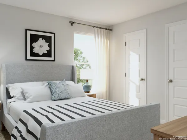 a bedroom with a bed and a potted plant