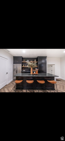 1276 West Fallow Way, Unit 76 Ogden, UT 84414 - Photo 13 of 22 Bar featuring parquet flooring, stainless steel fridge with ice dispenser, gray cabinets, dark countertops, and recessed lighting