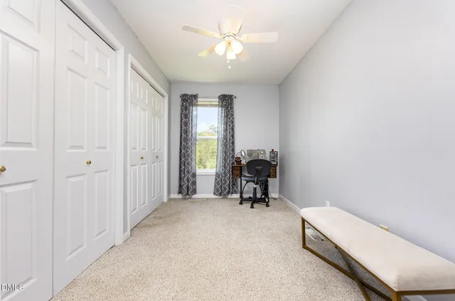 a spacious bedroom with a bed and a flat screen tv