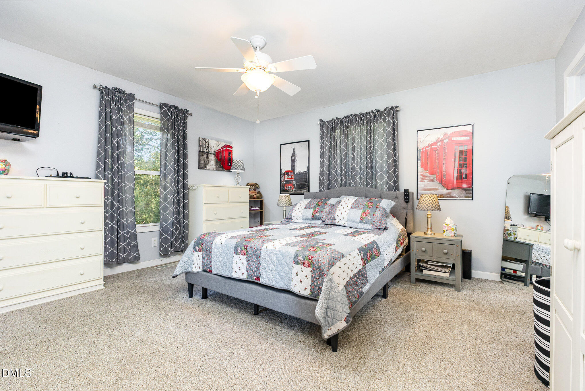 365 Landmark Road Willow Spring, NC 27592 - Photo 15 of 27 a spacious bedroom with a bed and a flat screen tv