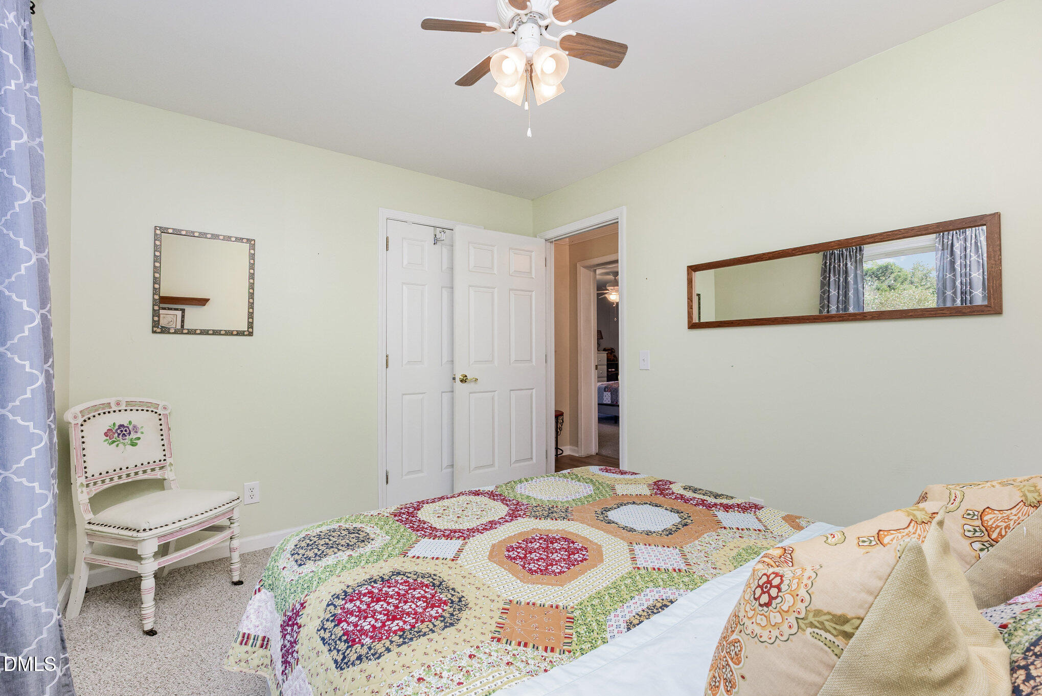 365 Landmark Road Willow Spring, NC 27592 - Photo 20 of 27 a bedroom with a bed and a chandelier