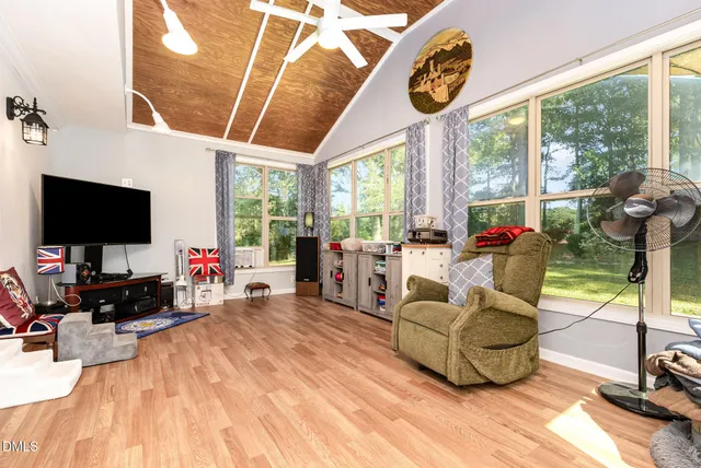 a bedroom with furniture and a flat screen tv