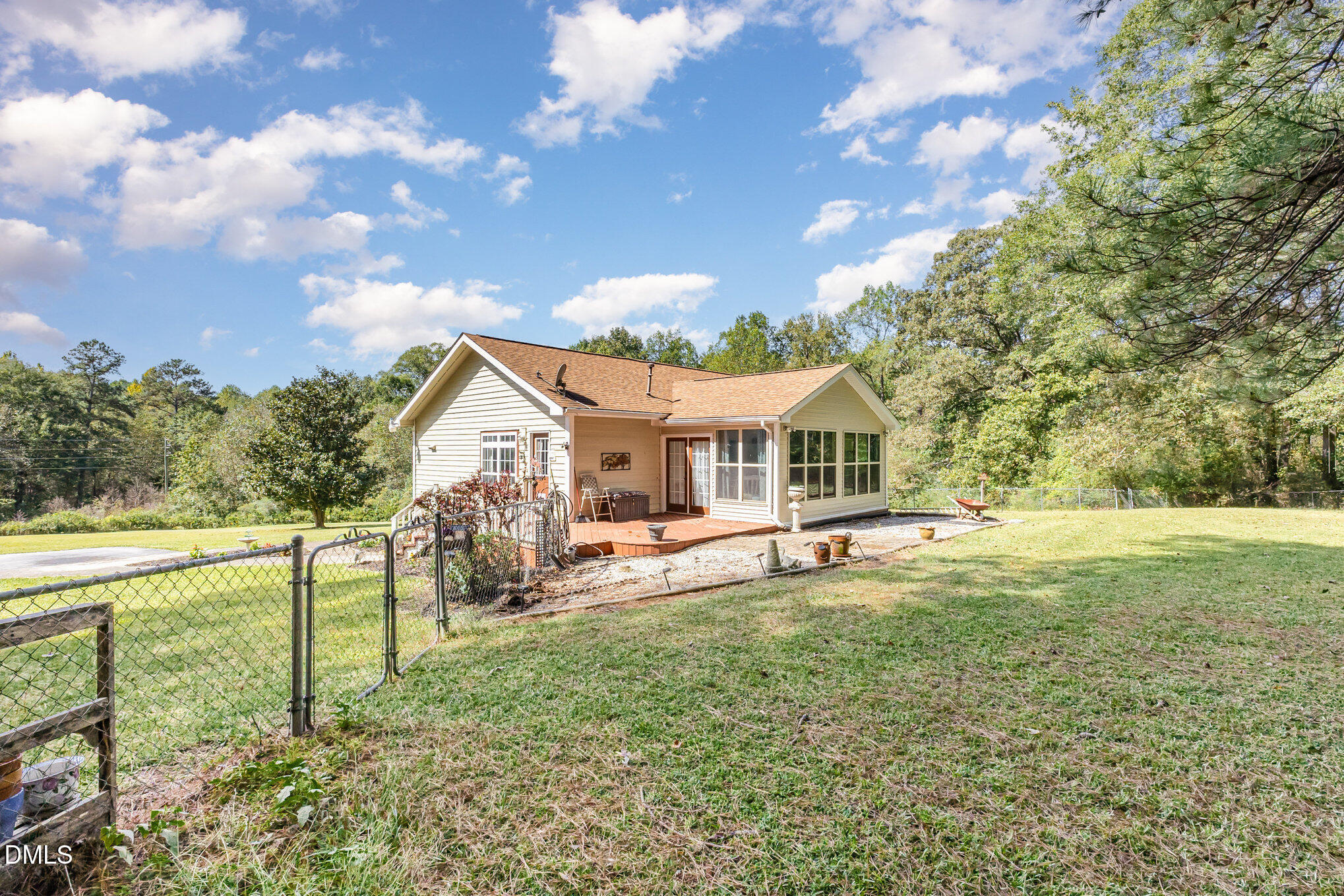 365 Landmark Road Willow Spring, NC 27592 - Photo 25 of 27 a house view with swimming pool and trees in the background