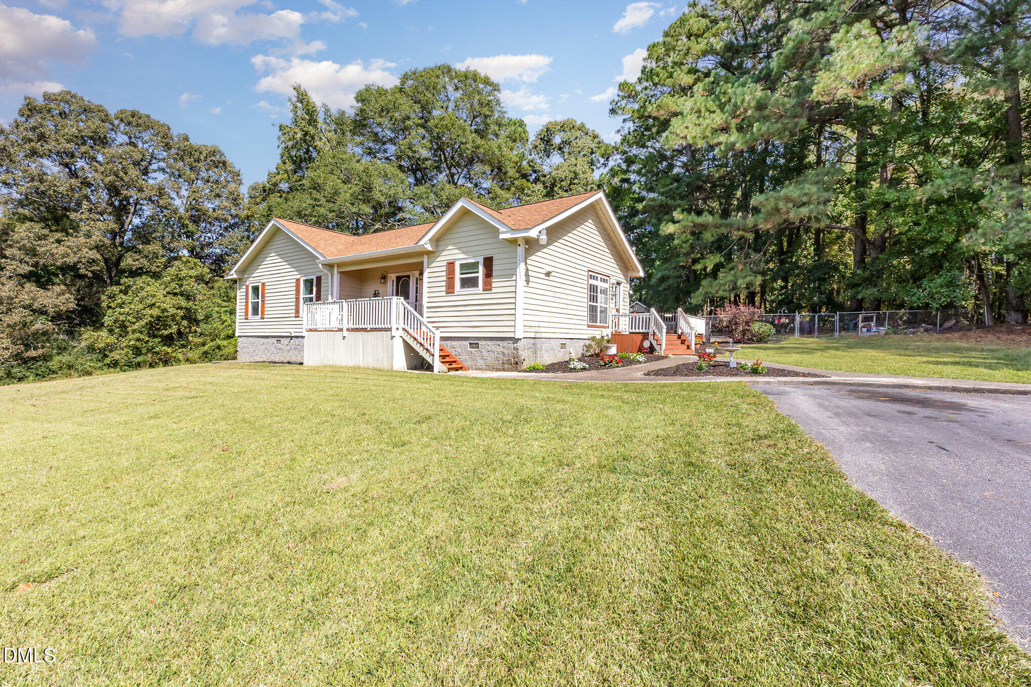 365 Landmark Road Willow Spring, NC 27592 - Photo 4 of 27 a view of a house with pool and chairs next to trees