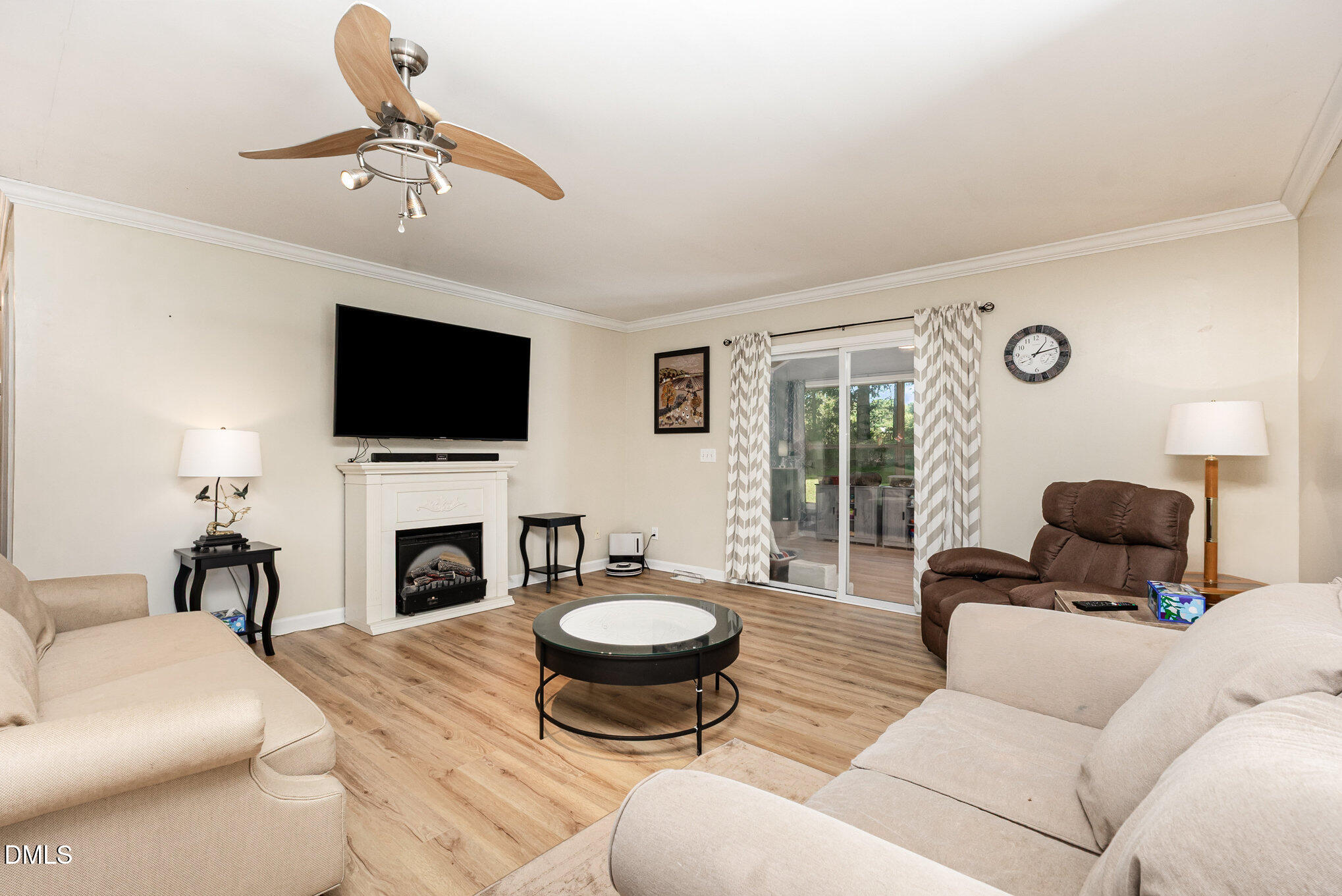 365 Landmark Road Willow Spring, NC 27592 - Photo 8 of 27 a living room with furniture a flat screen tv and a fireplace