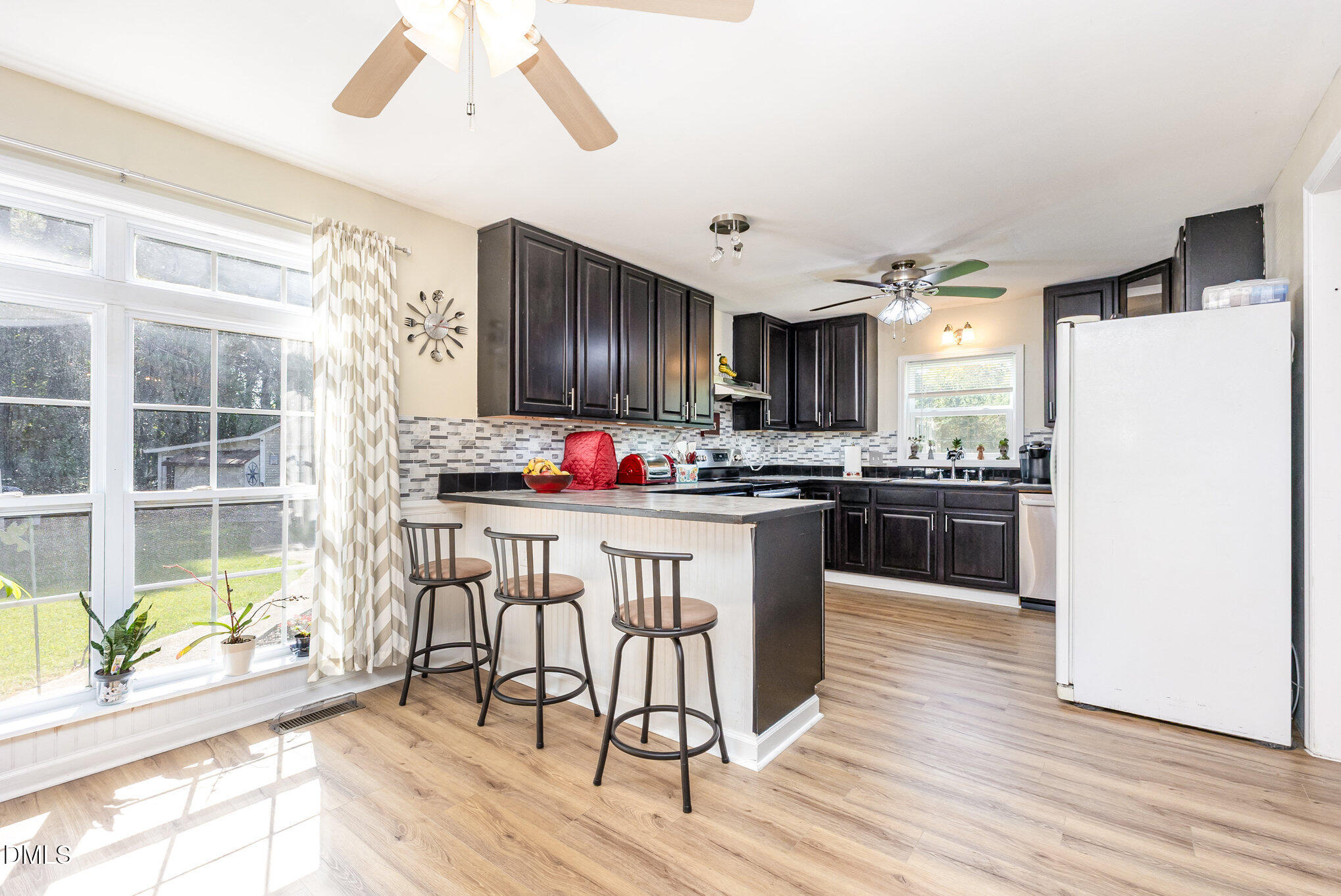 365 Landmark Road Willow Spring, NC 27592 - Photo 10 of 27 a kitchen with granite countertop a refrigerator cabinets and wooden floor