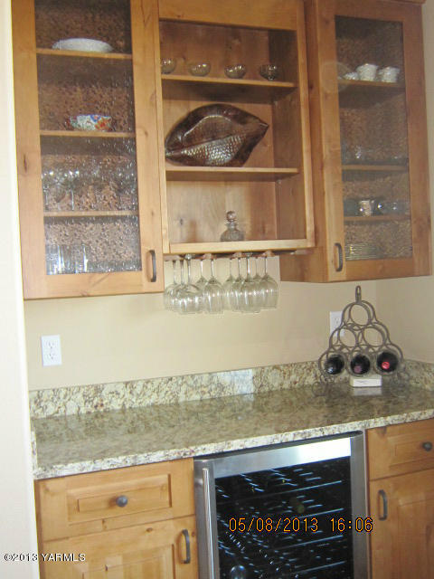 285 Cook Road Yakima, WA 98908 - Photo 26 of 26 a kitchen with granite countertop a stove and a white wooden cabinets
