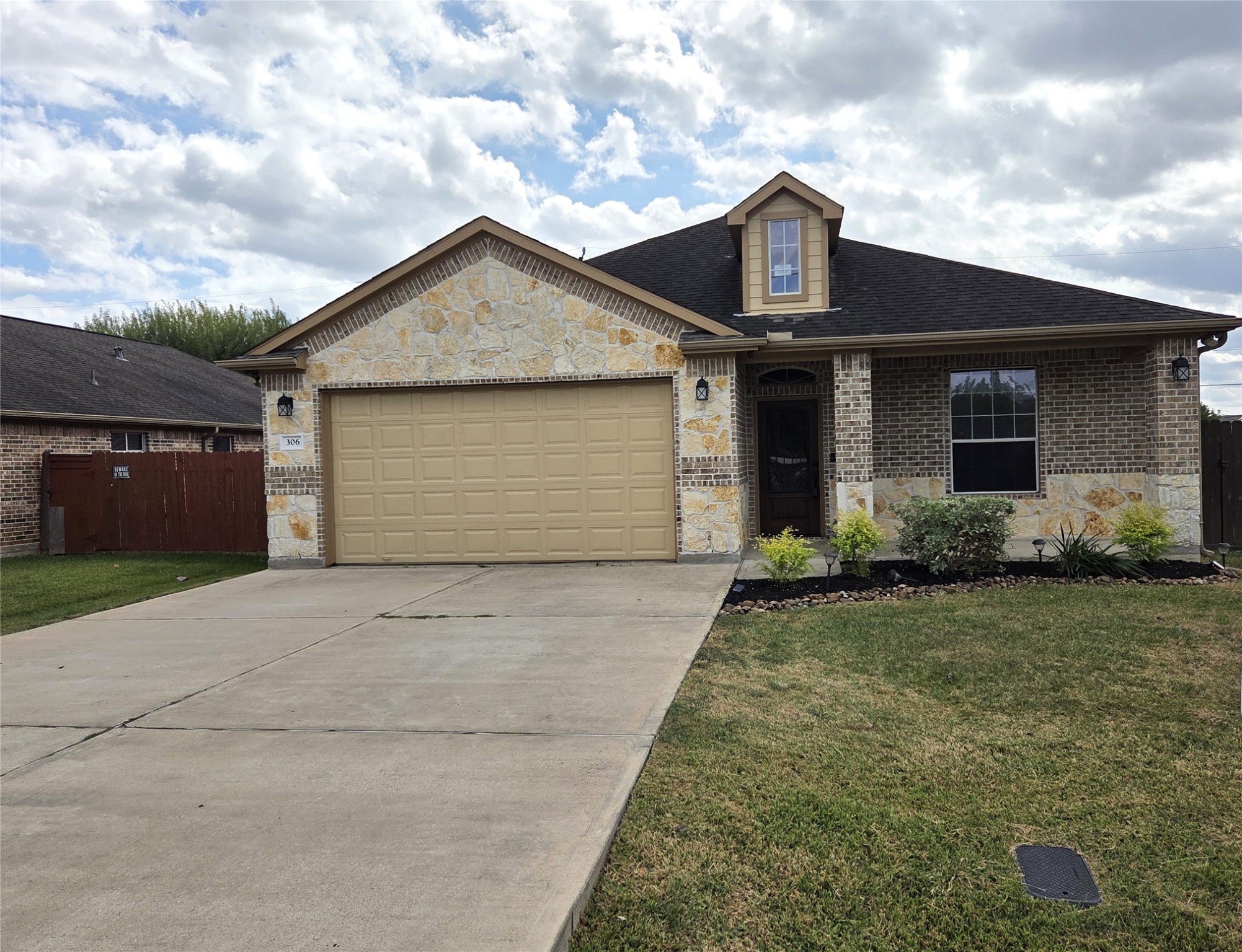a front view of a house with garden