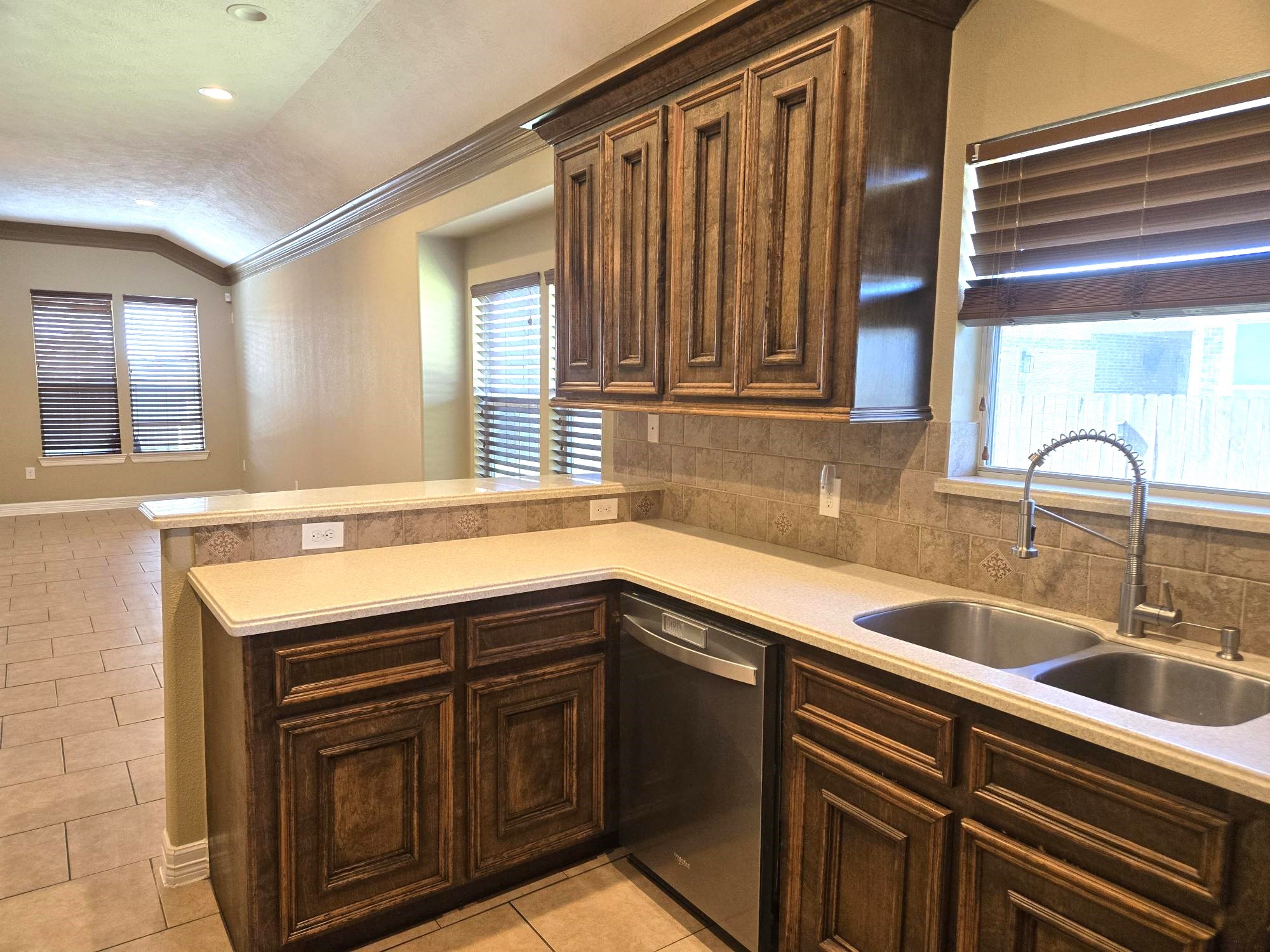 306 Masterson Street Arcola, TX 77583 - Photo 11 of 28 Kitchen: Double Sinks, Dish washer and Breakfast Bar open to family living room.