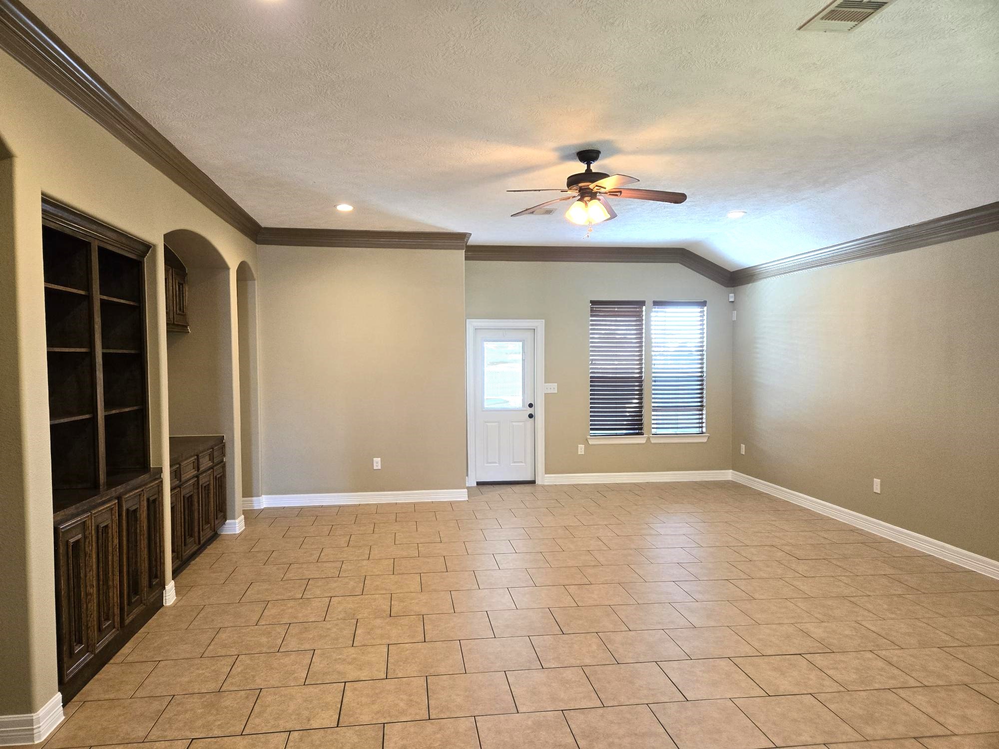 306 Masterson Street Arcola, TX 77583 - Photo 15 of 28 Spacious Living Room with door to the backyard and Covered Patio area.