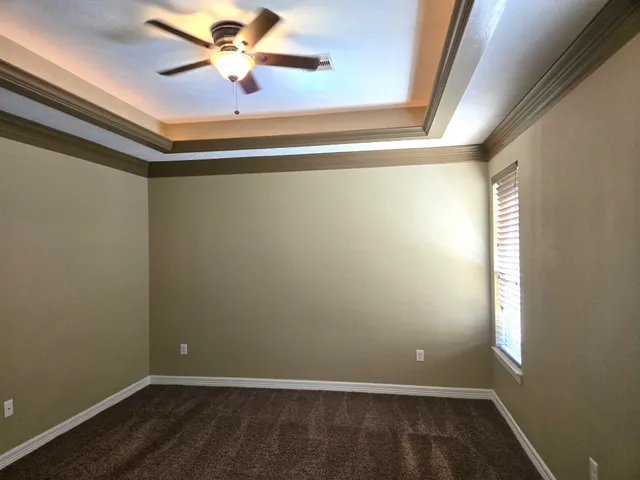 a view of room with window and a ceiling fan