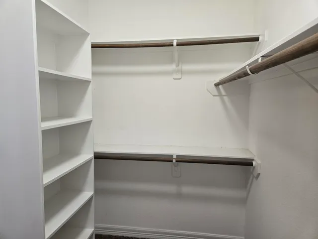 a view of an empty walk in closet
