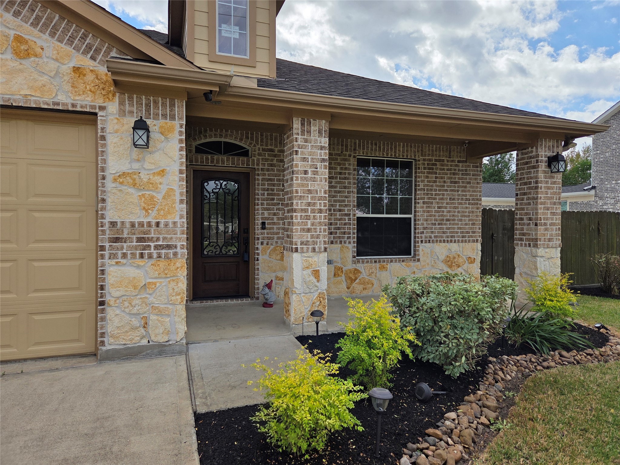 306 Masterson Street Arcola, TX 77583 - Photo 2 of 28 Landscaped flower beds view in front of the entryway, porch and home.
