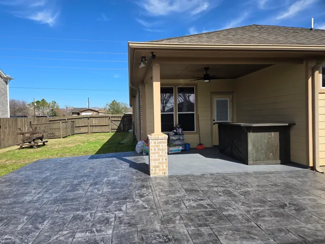 a backyard of a house with table and chairs