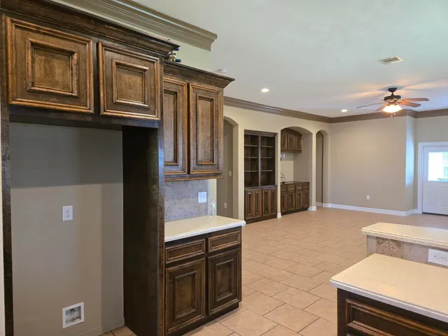 a view of kitchen with stainless steel appliances granite countertop cabinets and window