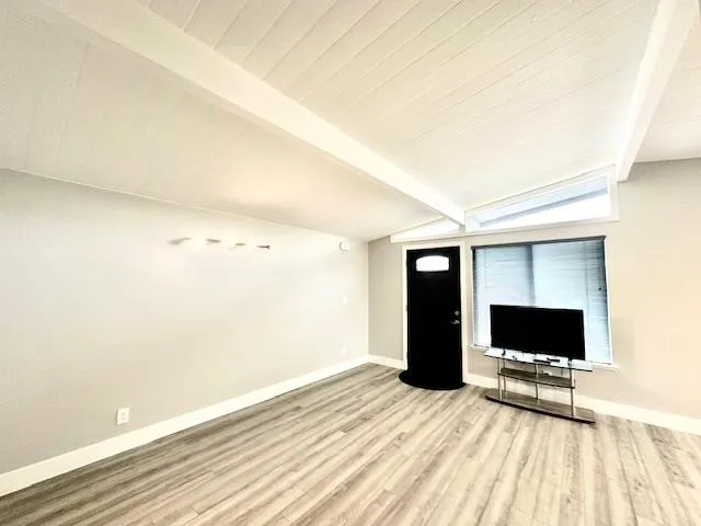 a room with a bed and a flat screen tv