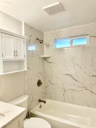 a bathroom with a bathtub and a shower