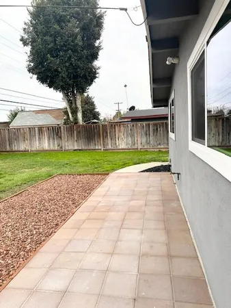 a backyard of a house with wooden fence