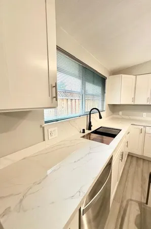 a view of a kitchen with a sink and cabinets
