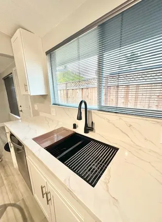 a kitchen with a sink a stove and a window