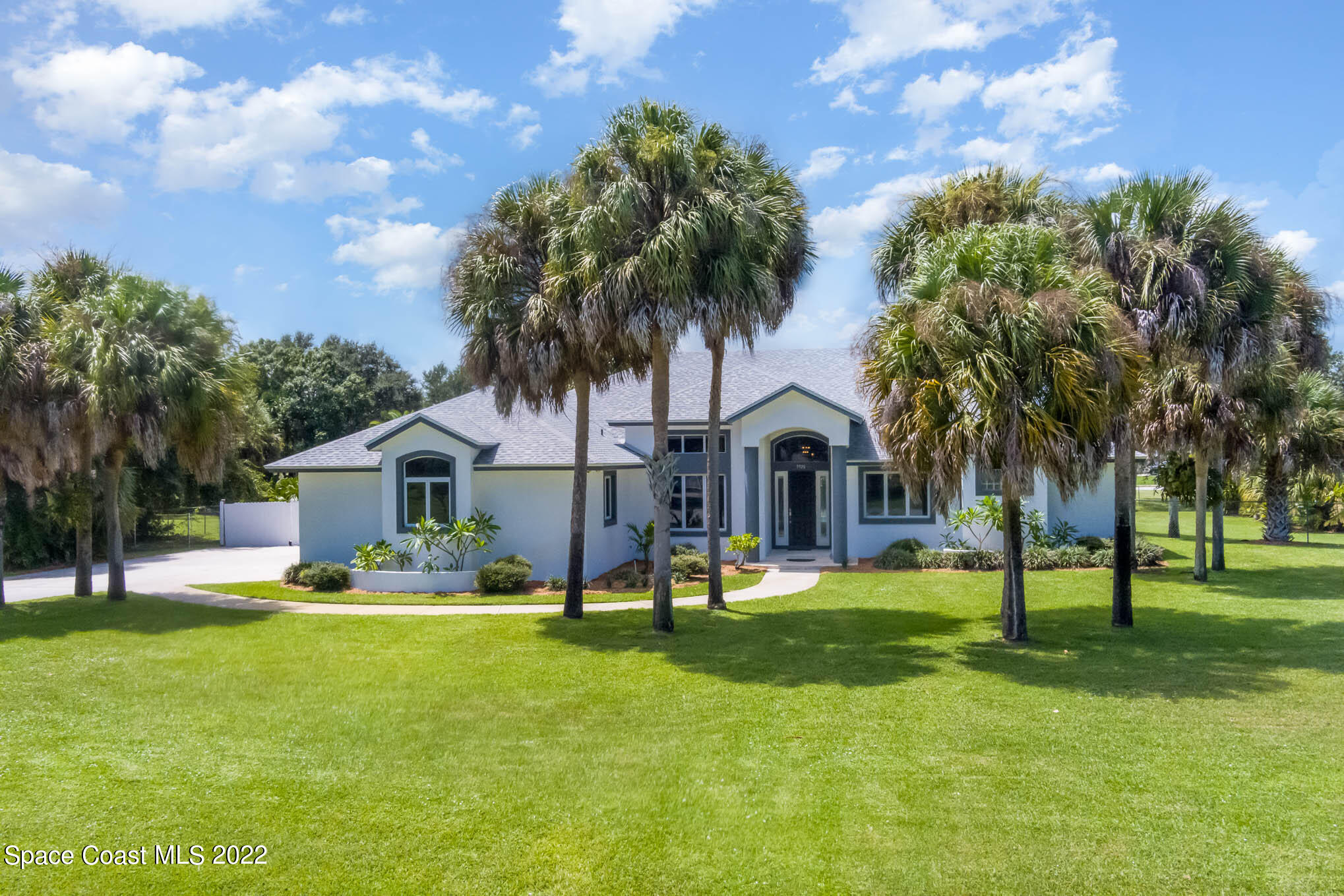 a front view of house with yard and green space
