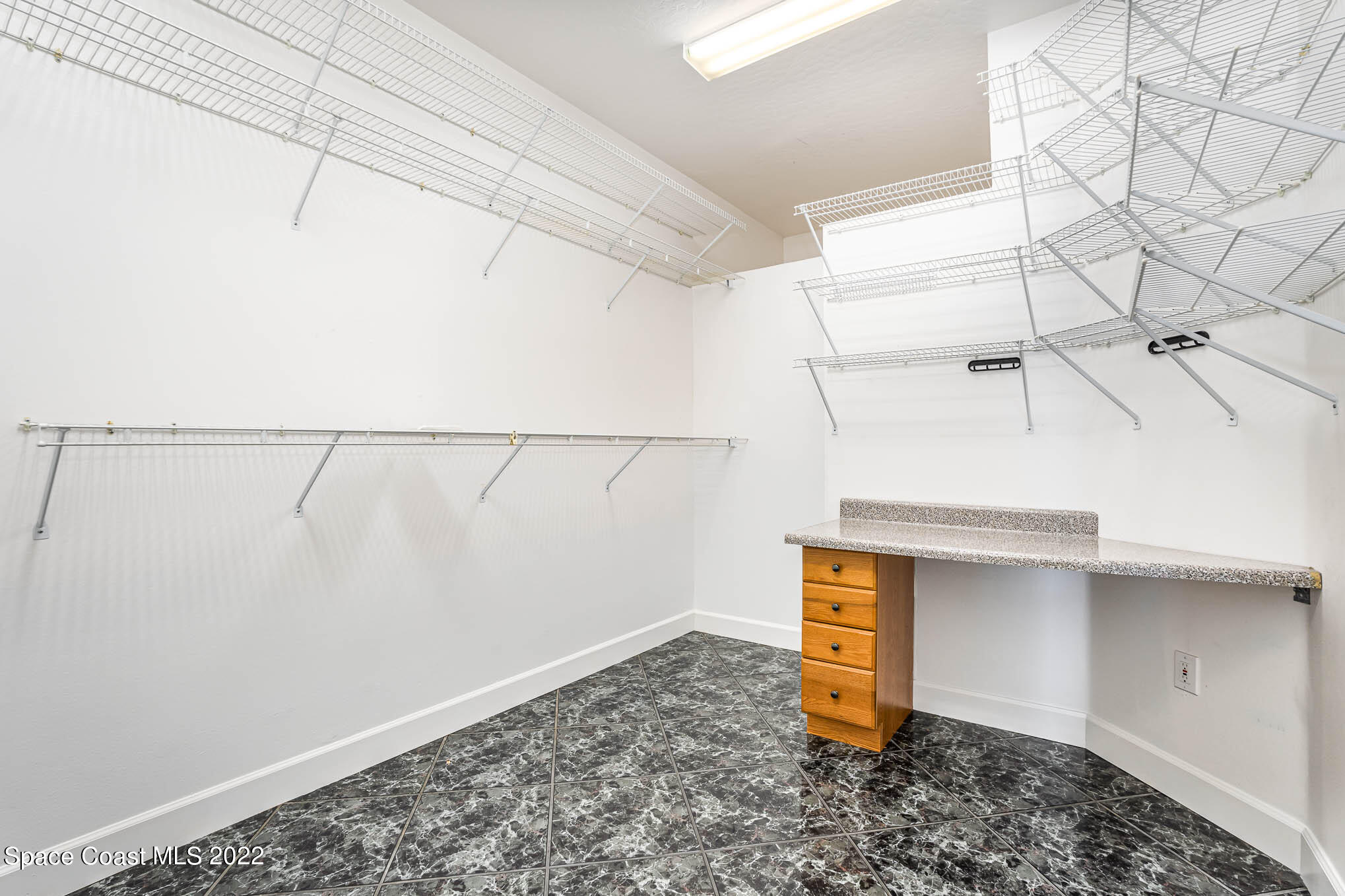 3920 Postridge Trail Melbourne, FL 32934 - Photo 13 of 52 a view of a storage & utility room with racks on the wall