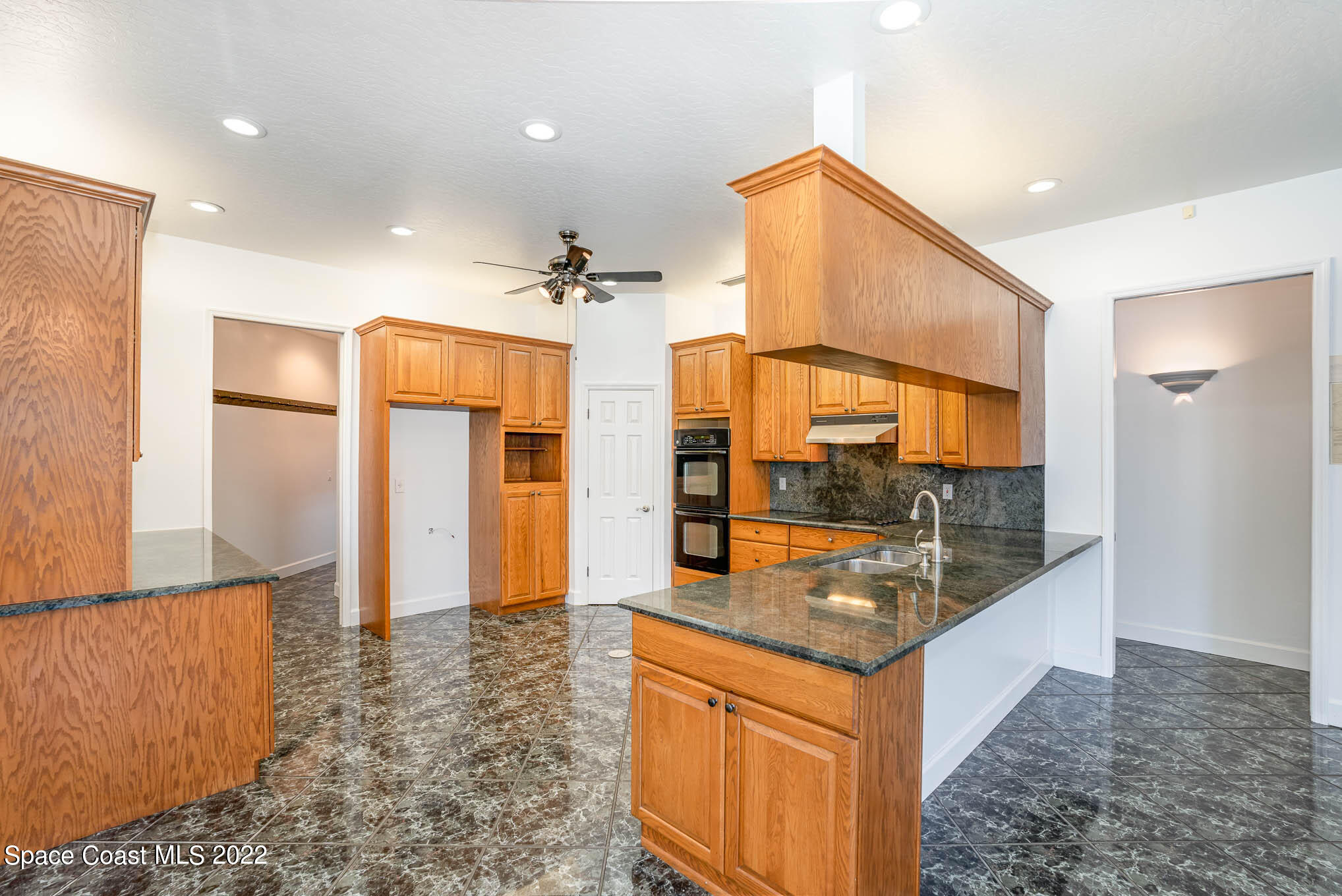 3920 Postridge Trail Melbourne, FL 32934 - Photo 21 of 52 a large bathroom with a granite countertop sink and a large mirror