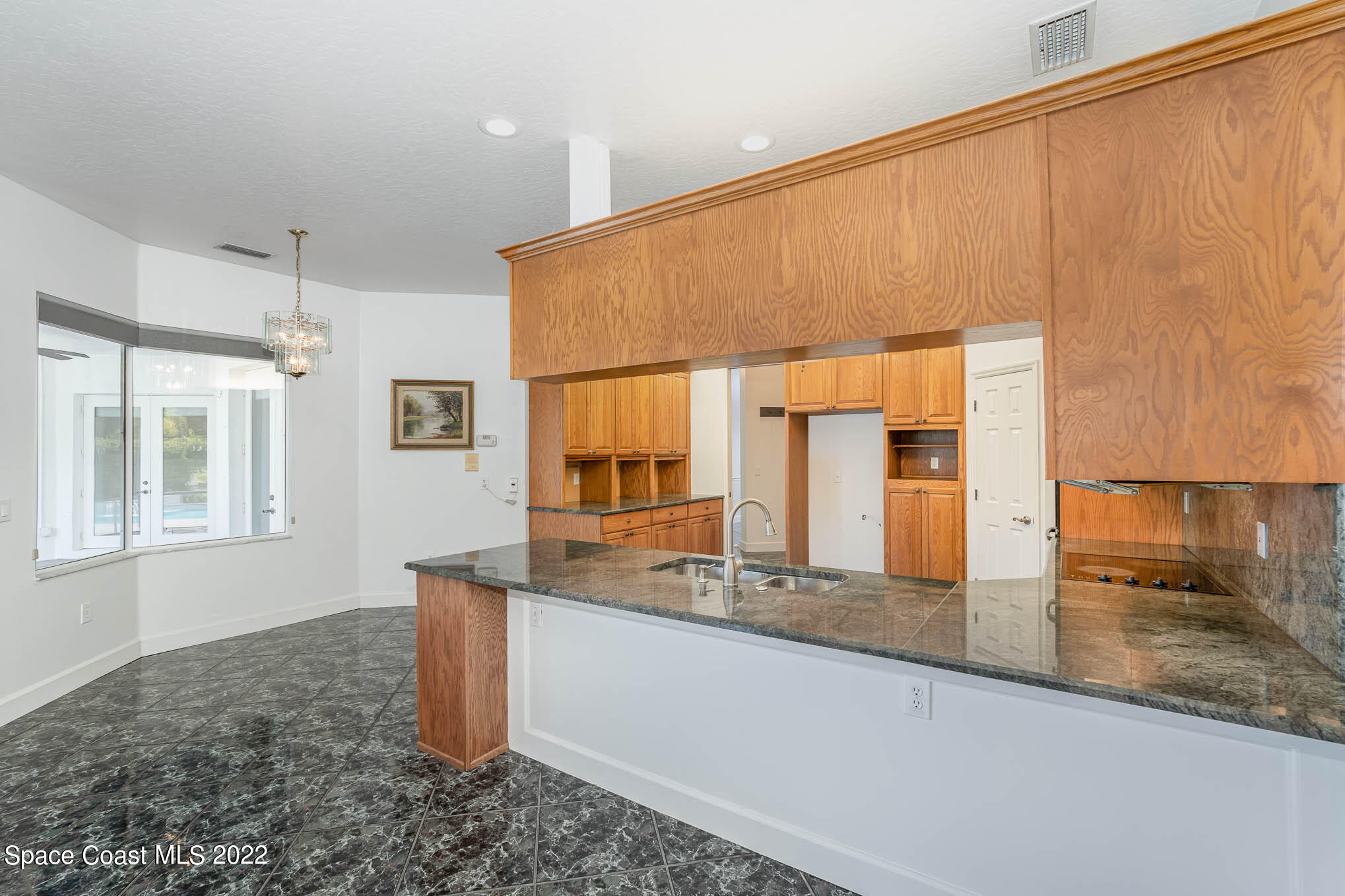 3920 Postridge Trail Melbourne, FL 32934 - Photo 22 of 52 a bathroom with a granite countertop sink and a mirror