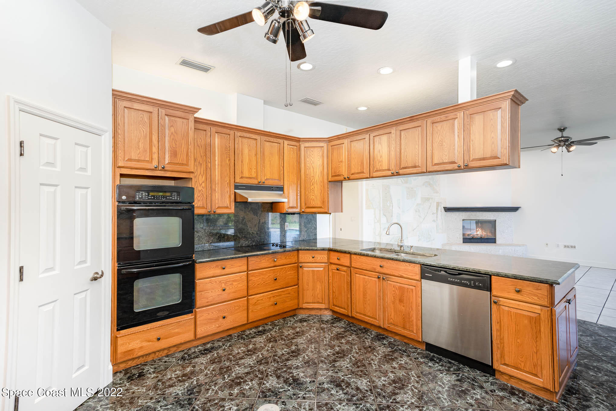 3920 Postridge Trail Melbourne, FL 32934 - Photo 23 of 52 a kitchen with granite countertop a sink stainless steel appliances and cabinets