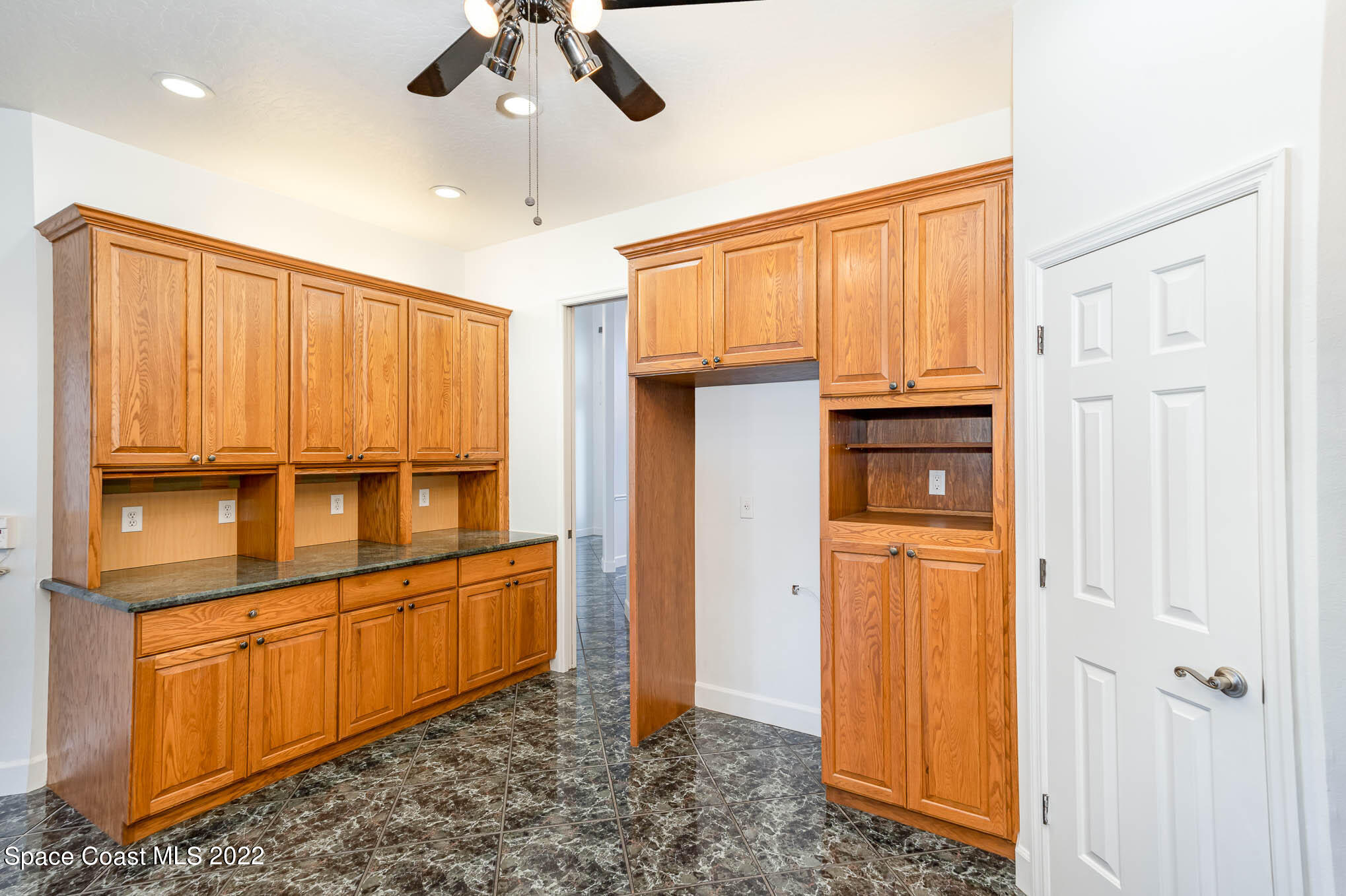3920 Postridge Trail Melbourne, FL 32934 - Photo 24 of 52 a view of a kitchen with refrigerator and cabinet