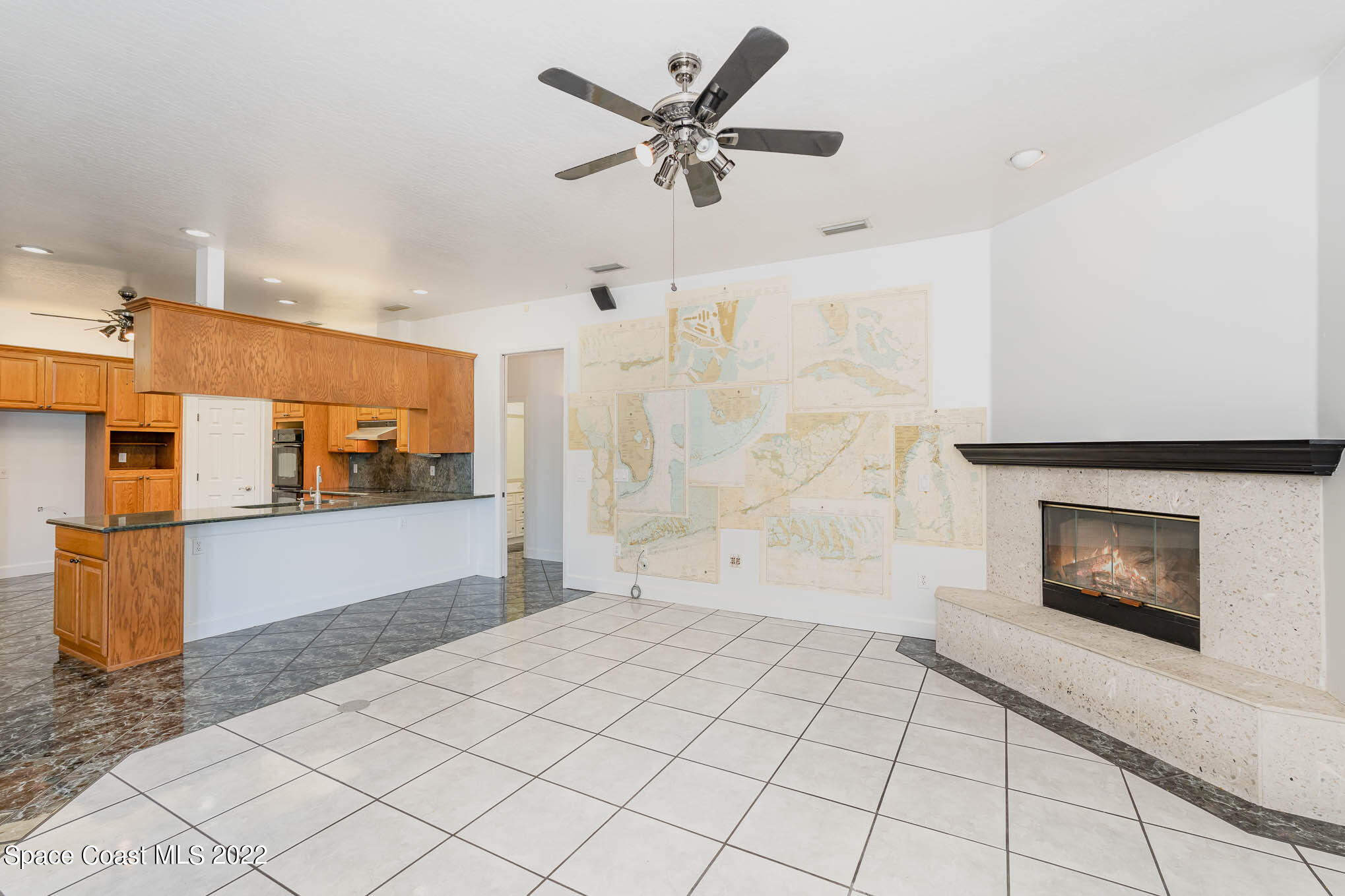3920 Postridge Trail Melbourne, FL 32934 - Photo 27 of 52 a living room with stainless steel appliances kitchen island granite countertop a rug a stove and a refrigerator