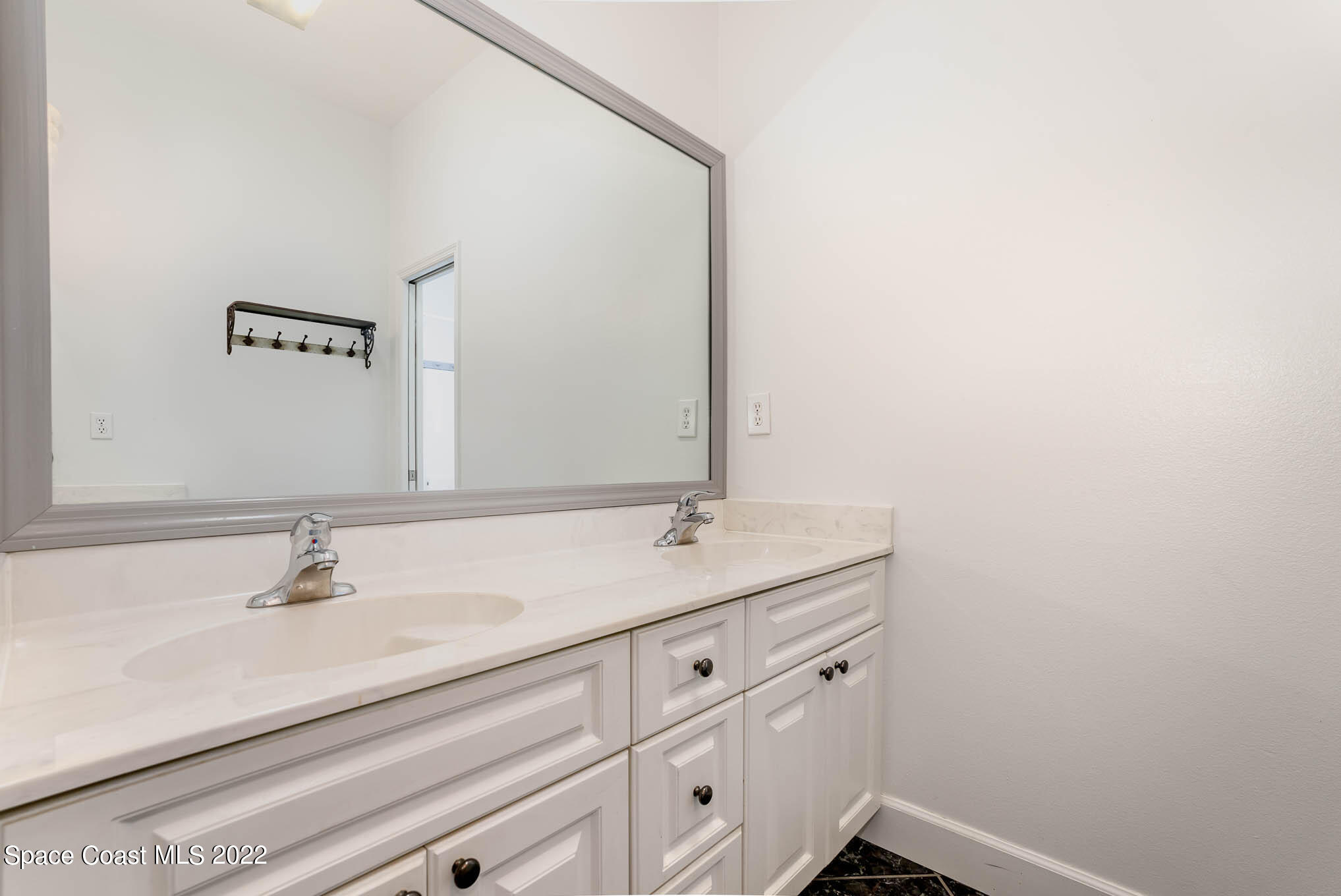 3920 Postridge Trail Melbourne, FL 32934 - Photo 32 of 52 a bathroom with a sink and a mirror