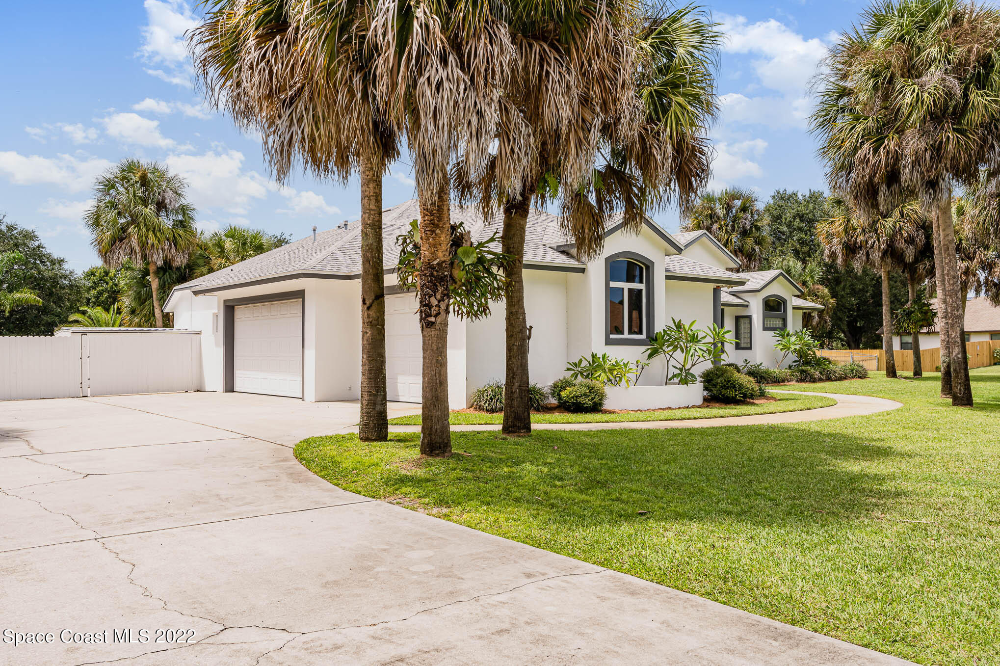 3920 Postridge Trail Melbourne, FL 32934 - Photo 45 of 52 a front view of a house with a garden and trees