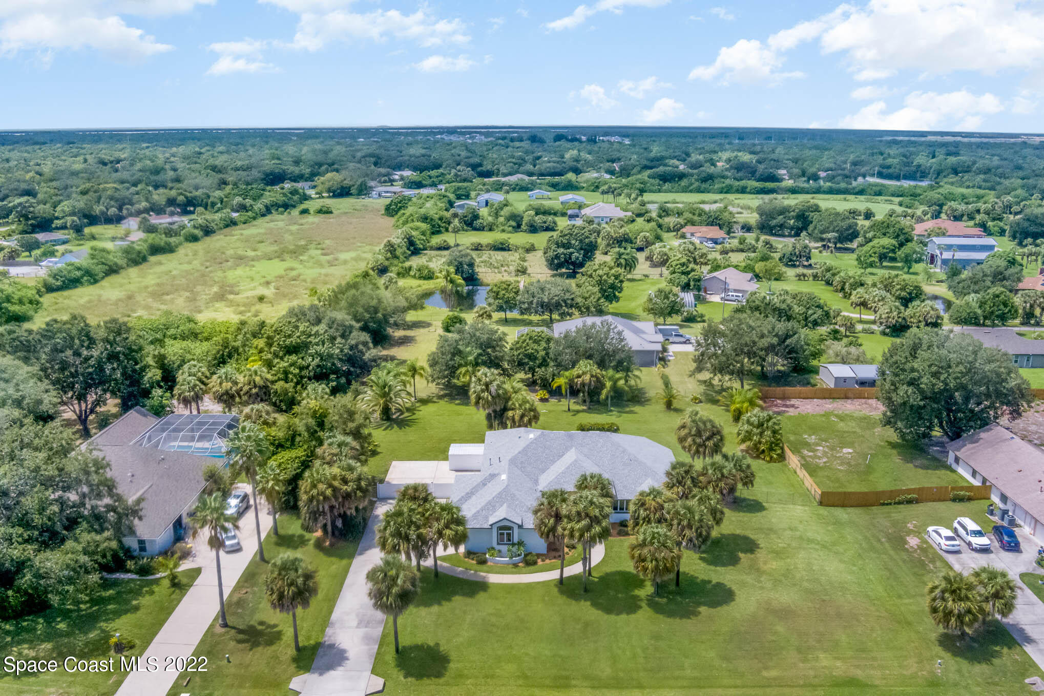 3920 Postridge Trail Melbourne, FL 32934 - Photo 51 of 52 an aerial view of residential houses with outdoor space and trees