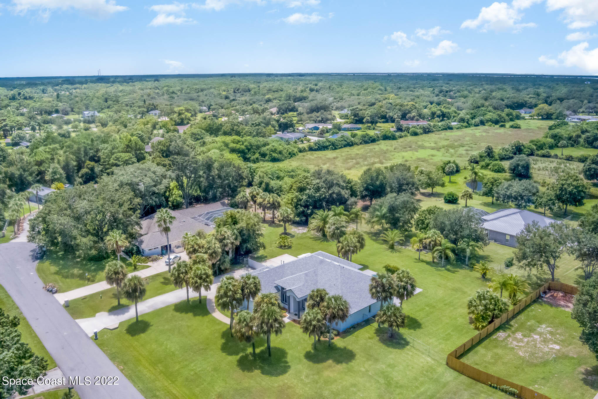 3920 Postridge Trail Melbourne, FL 32934 - Photo 52 of 52 an aerial view of a houses with a yard and lake