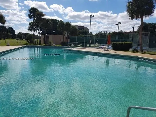 a view of a swimming pool and a yard