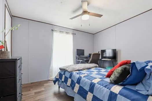 a bedroom with a bed and a chandelier