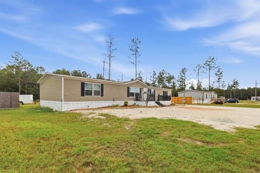 12947 Ralston Drive Conroe, TX 77306 - Photo 5 of 24 a view of a house with a yard and a large tree