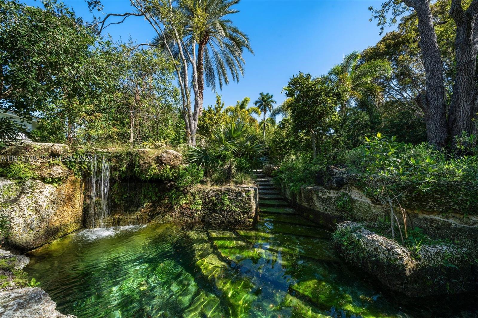 12050 Moss Ranch Road Pinecrest, FL 33156 - Photo 11 of 33 a view of a garden with a house