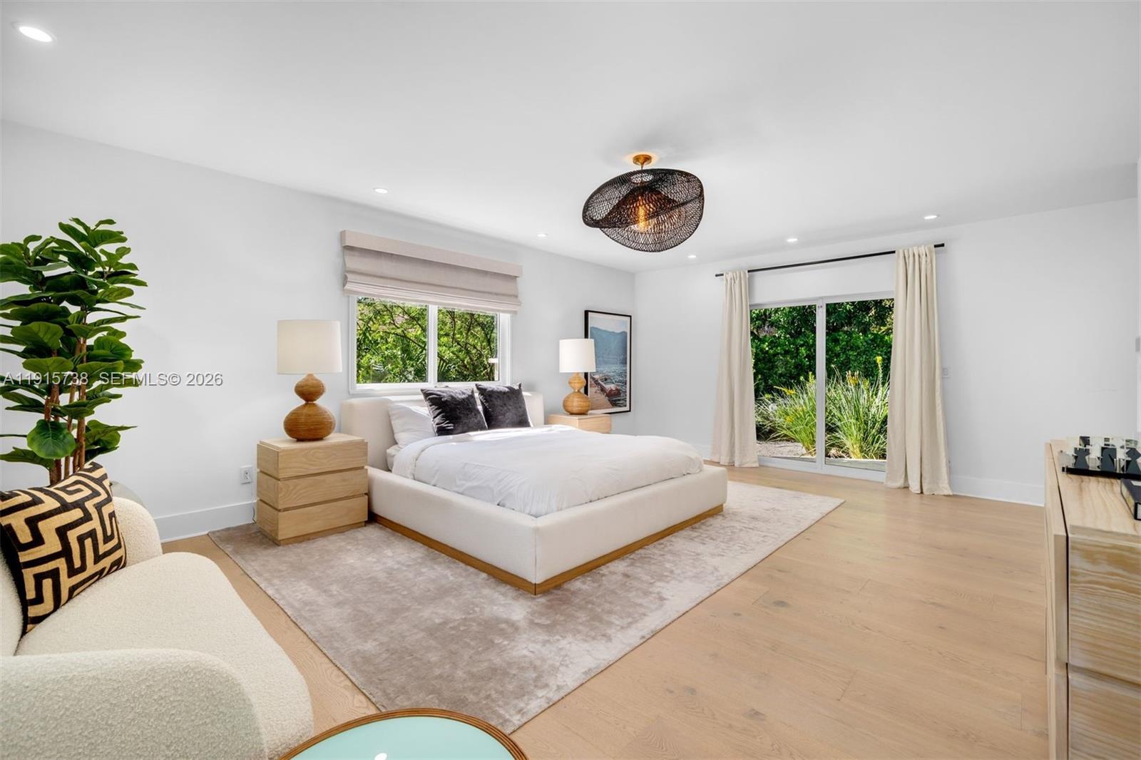 12050 Moss Ranch Road Pinecrest, FL 33156 - Photo 13 of 33 a bedroom with furniture and a large window