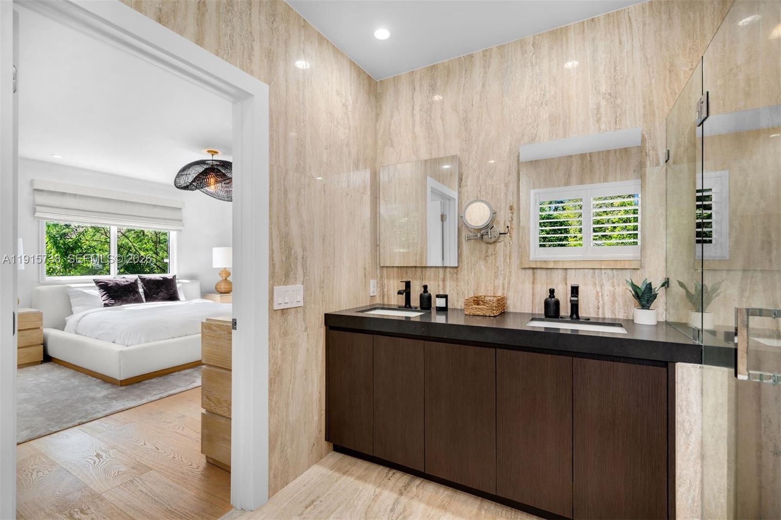 12050 Moss Ranch Road Pinecrest, FL 33156 - Photo 14 of 33 a bathroom with a double vanity sink a mirror and a shower
