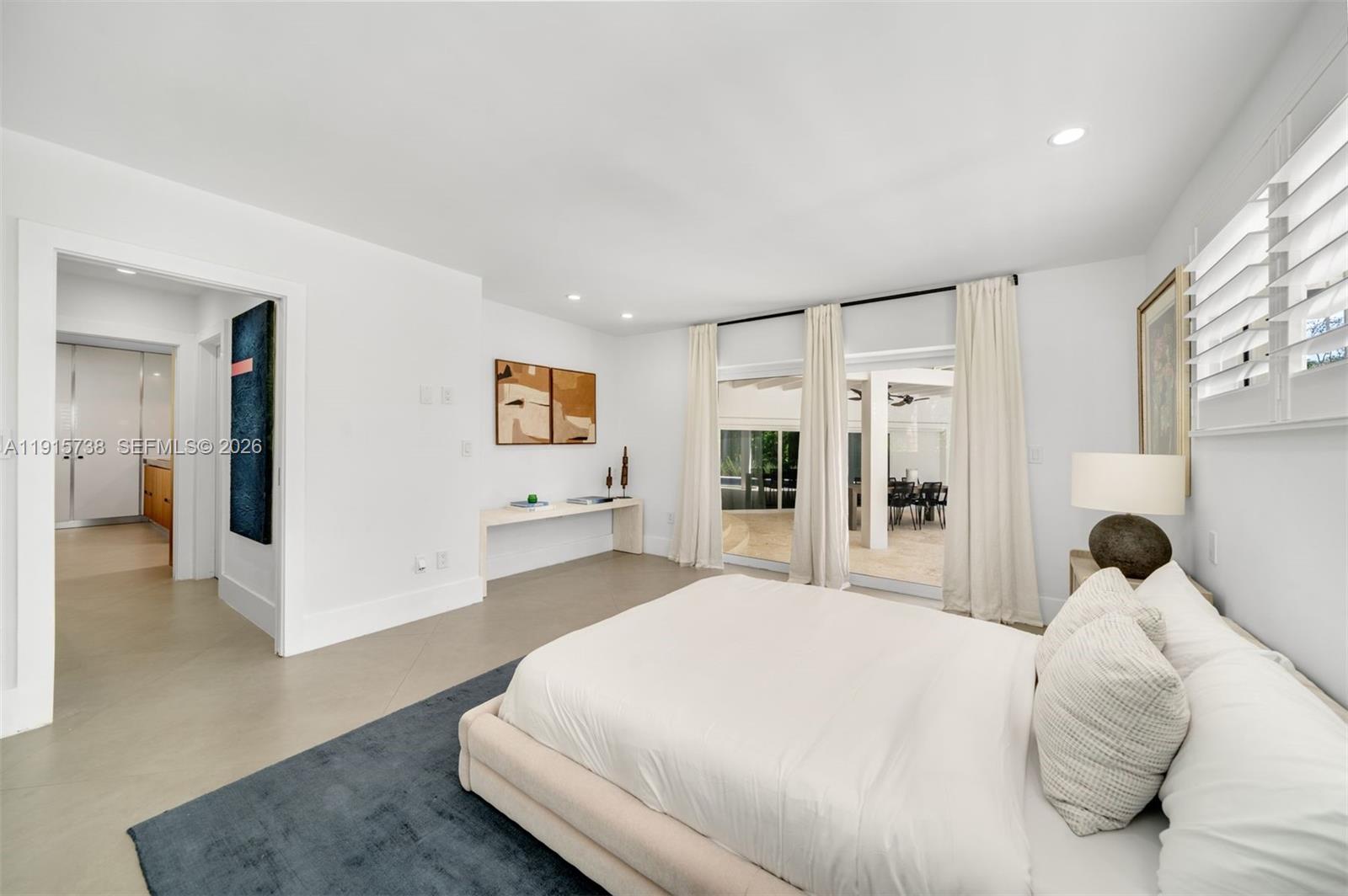 12050 Moss Ranch Road Pinecrest, FL 33156 - Photo 16 of 33 a bedroom with a white bed and white cabinets