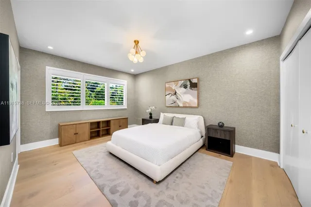 a bedroom with a large bed and a window