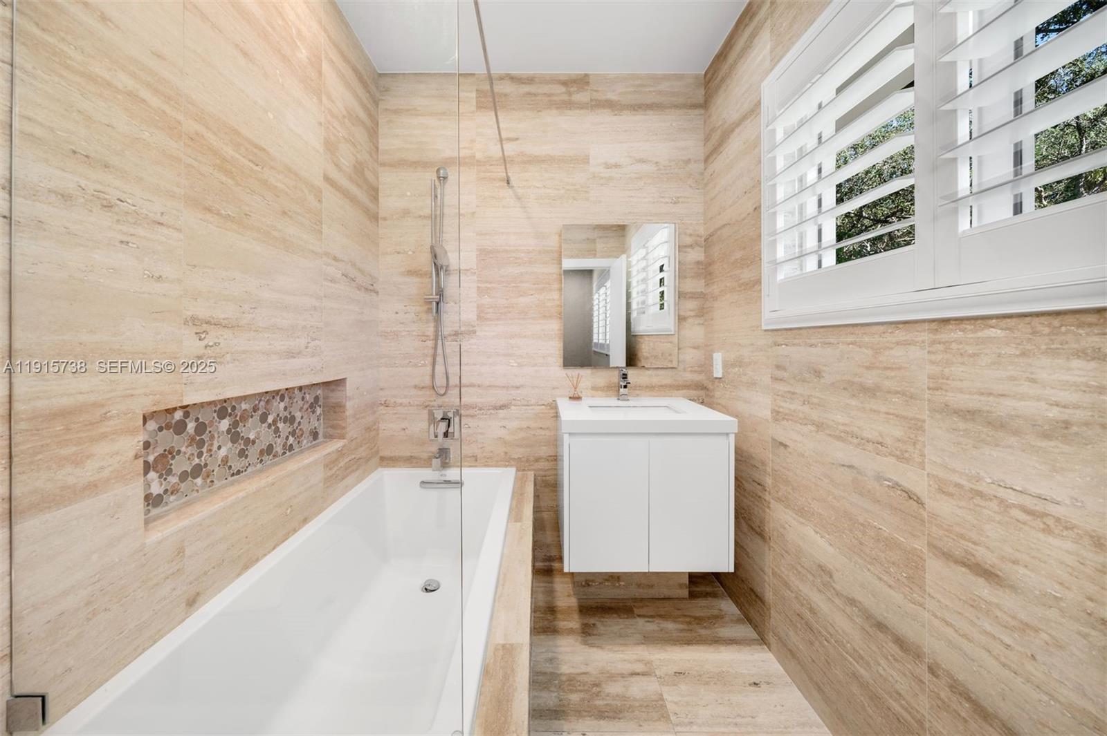 12050 Moss Ranch Road Pinecrest, FL 33156 - Photo 18 of 27 a bathroom with a sink a toilet and shower