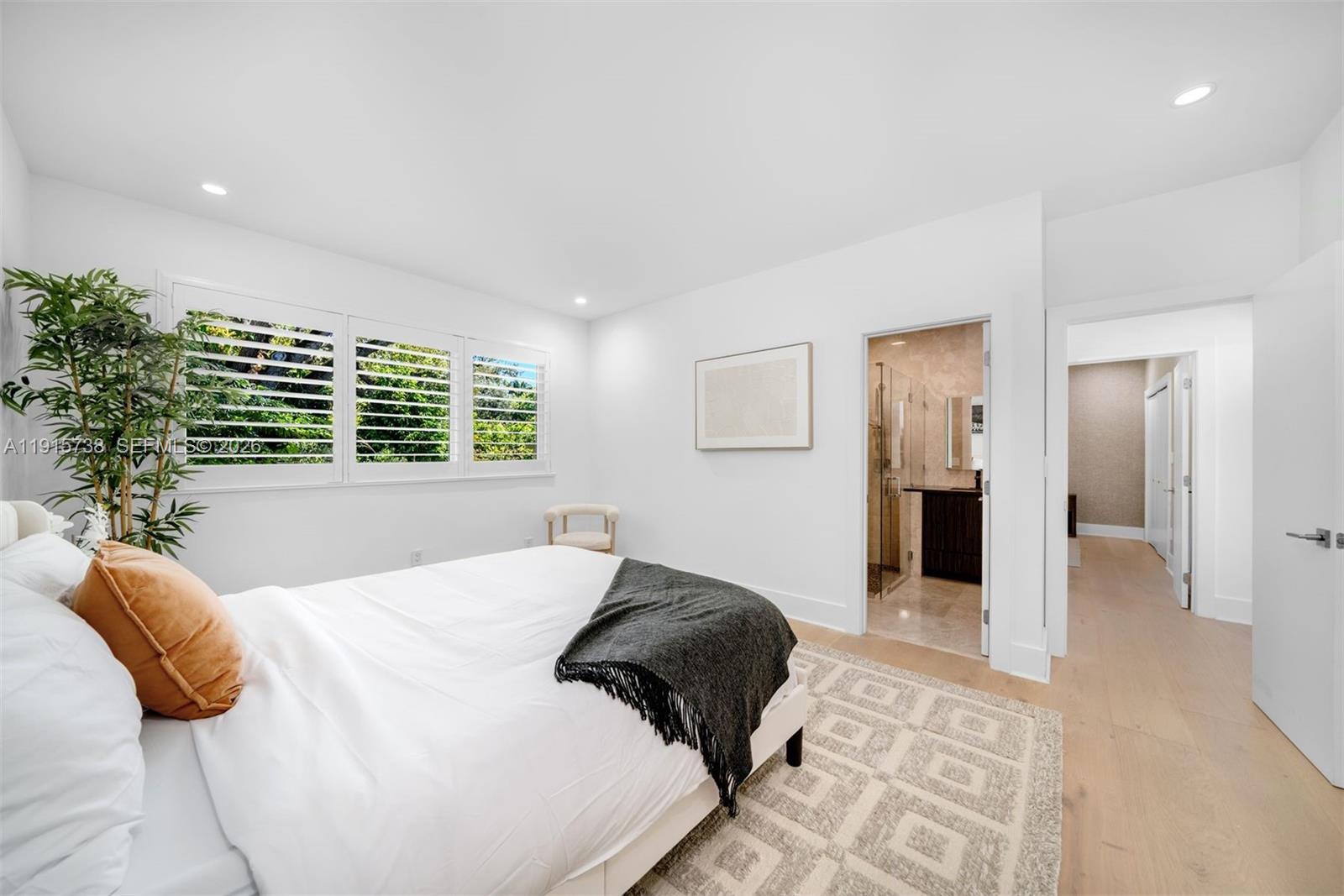 12050 Moss Ranch Road Pinecrest, FL 33156 - Photo 19 of 33 a bedroom with a large bed and a window